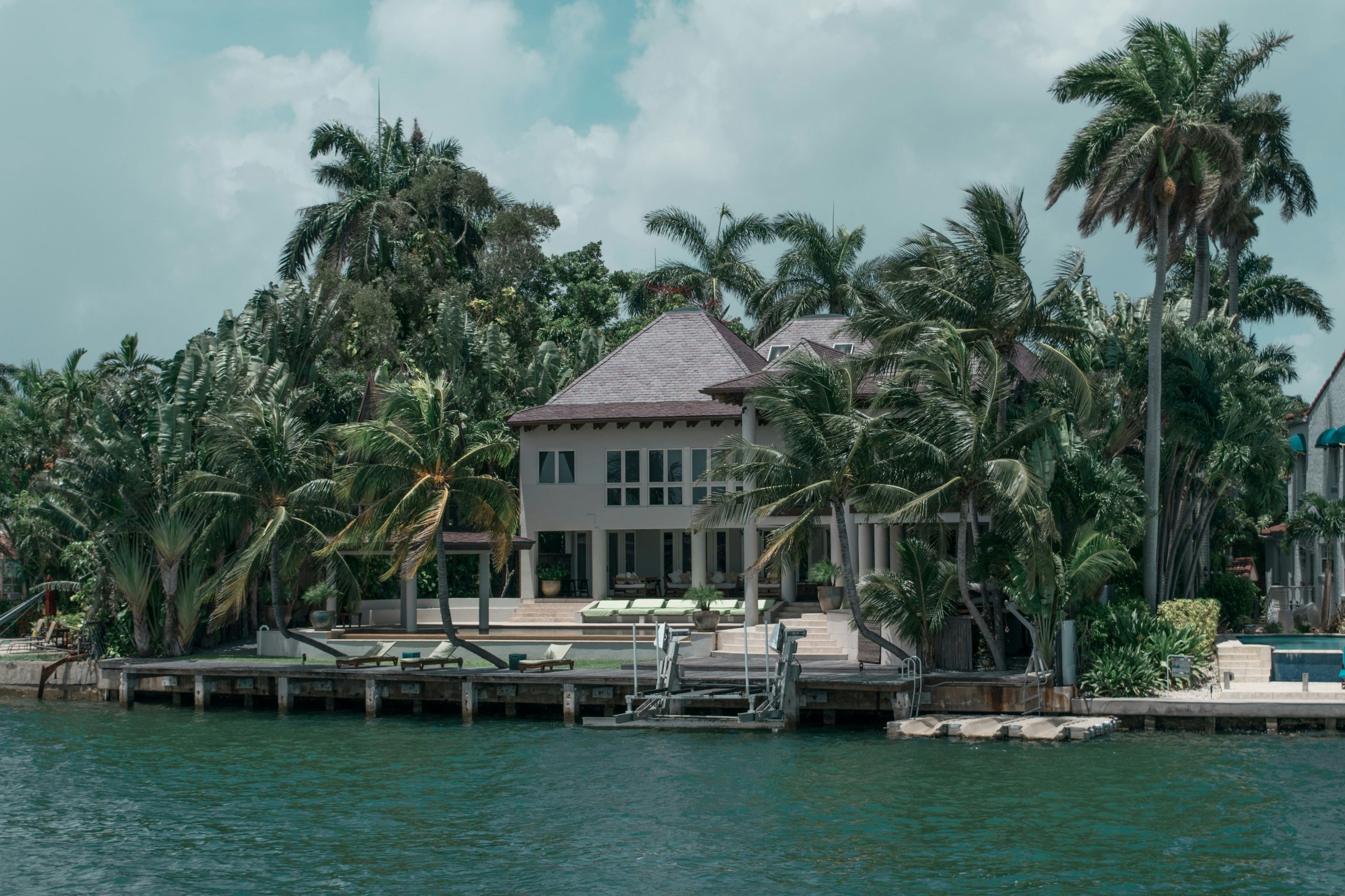 Florida bayfront home framed by palm trees